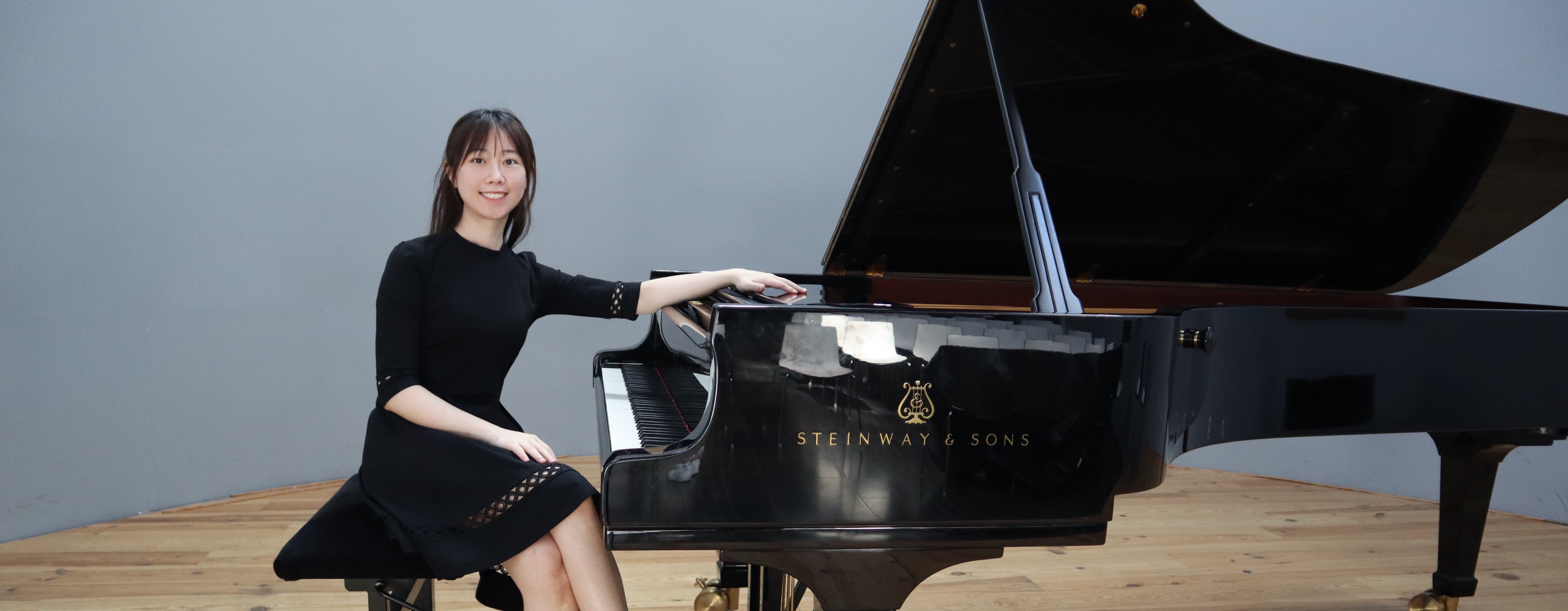 Pianist sitting on a grand piano